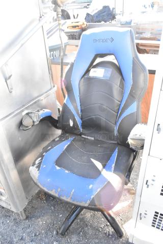 Emerge blue and black gaming chair on casters, showing significant wear and tear, with peeling upholstery and visible padding.