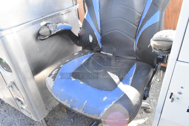 Emerge blue and black gaming chair on casters, showing significant wear and damage to the seat and armrests.