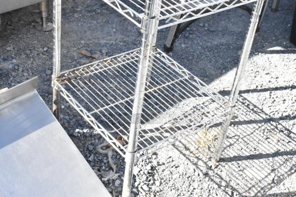 Chrome finish 5-tier wire shelving unit outdoors, fair condition, buyer must dismantle, freight charges applicable.