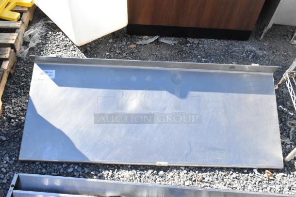 Metal wall mount shelf and kickplate for reach-in, showing minor surface marks. Tag indicates item 293 in Quantity X.YZ.