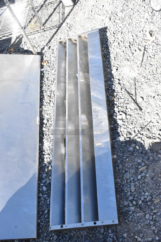 Two metal pieces including a wall mount shelf and kickplate for reach-in. Items show light wear, ideal for commercial use.