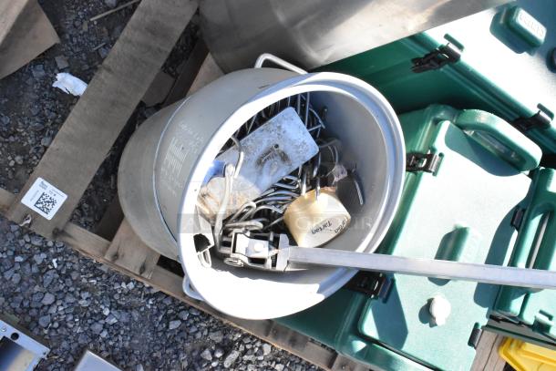 Pallet lot with metal trash can, beverage holder dispensers, wet floor signs; assorted items and tools visible inside.