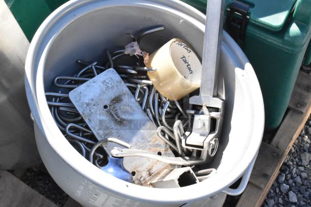 Pallet lot including metal trash can filled with various metal items and a Tartan tape roll, showing light wear.