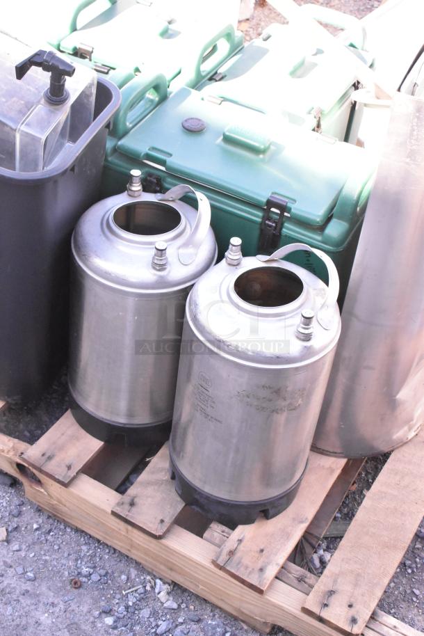 Pallet of mixed items including metal canisters, green plastic dispensers, and industrial containers, varying condition.
