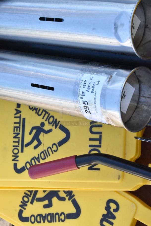 Pallet lot with metal trash can, beverage dispensers, and wet floor caution signs, with visible auction label.