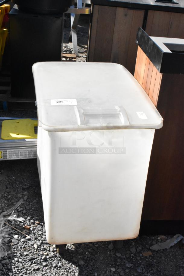 White poly ingredient bin with lid on commercial casters, showing moderate wear. Lot label "296" attached.