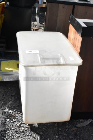 White poly ingredient bin with lid on commercial casters, showing moderate wear. Lot label "296" attached.
