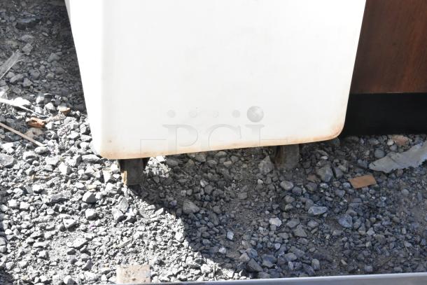 White poly ingredient bin with commercial casters, visible wear at base. Ideal for kitchen or commercial use.