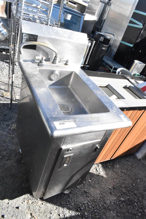 Stainless steel single bay sink with faucet, used condition, attached storage cabinet, visible label with number 298.