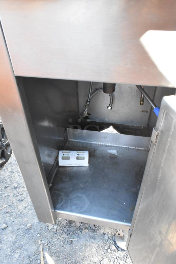 Stainless steel single bay sink with plumbing visible underneath. Good condition, sturdy construction, suitable for commercial use.