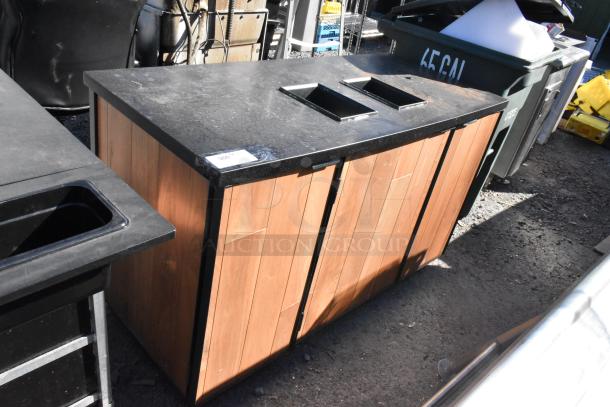 Wood pattern trash can shell with two deposit holes and three doors, in used condition, suitable for commercial use.