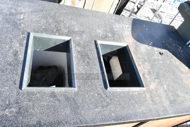 Wood pattern trash can shell with two trash deposit holes. Features three doors for access. Used condition, visible wear.