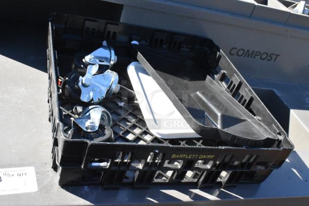 Black crate with four swivel casters and components. "Bartlett Dairy" marked on the crate.