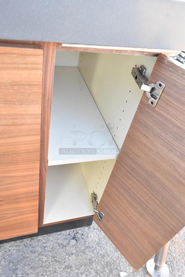 Wood pattern trash can shell with 3 deposit holes and 4 doors. Open door reveals shelved interior. Good condition.