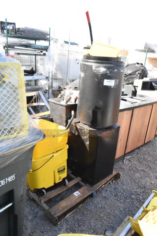 Yellow poly mop bucket on pallet with trash cans, used condition. Includes warning label. All items sold together.