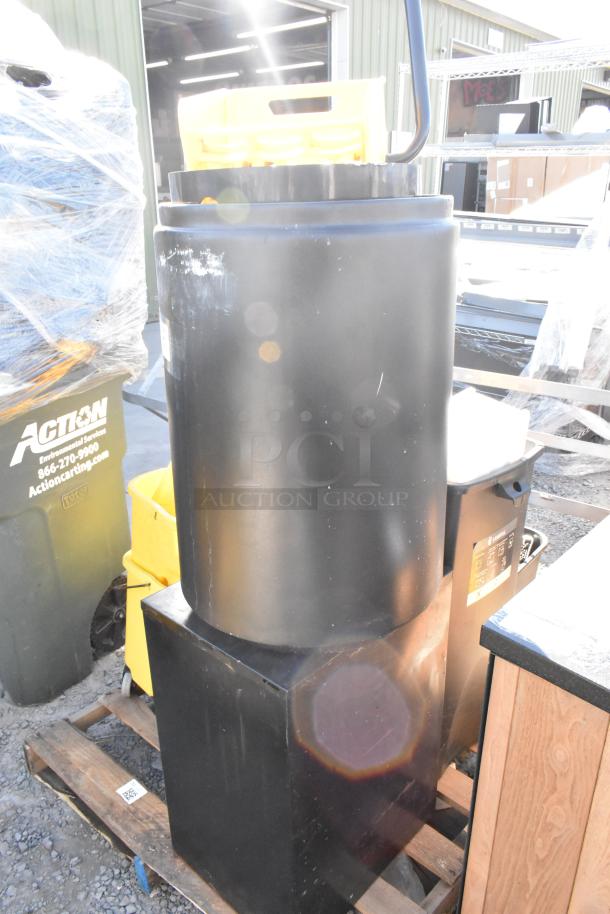 Yellow Poly Mop Bucket on pallet with various items, including trash cans. Visible wear and outdoor setting.