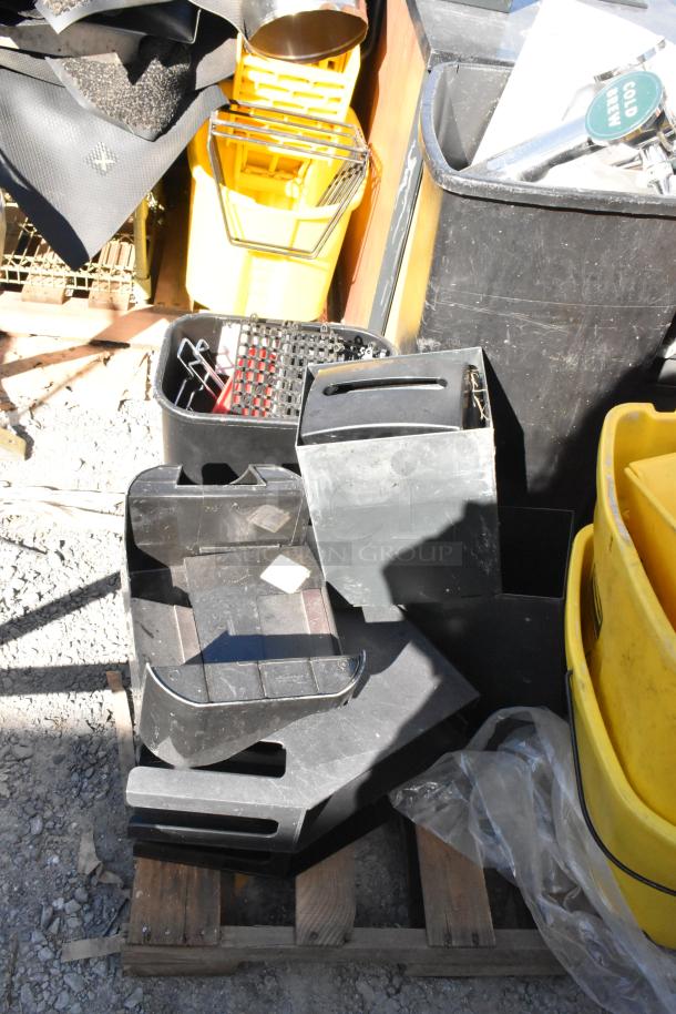 Pallet lot with yellow poly mop bucket, black trash cans, and various items. Used condition, ideal for janitorial use.