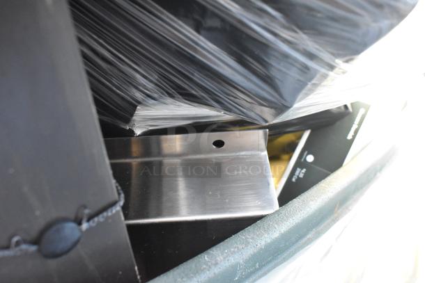 Poly trash can containing various items, including metal brackets and plastic wraps. Visible wear and elements suggest diverse contents.