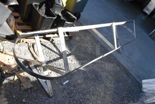 Steel metal pot rack, sturdy frame, good condition, elongated oval shape, suitable for kitchen storage. No visible labels.