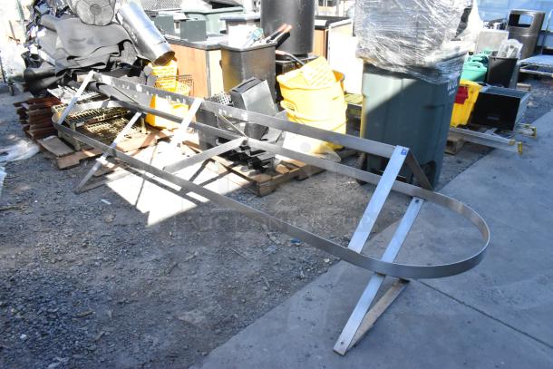 Large metal pot rack, oval shape with slatted design, in used condition, ideal for kitchen storage.