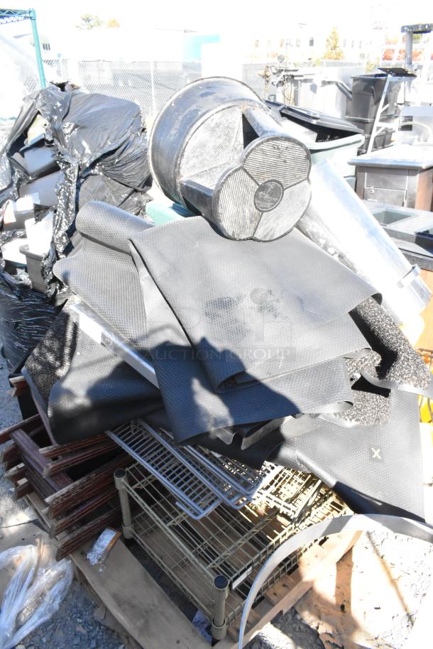 Pallet lot with floor mats, stool, serving tray stands; various items in mixed condition on a wooden pallet.