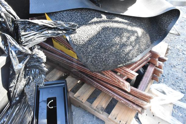 Pallet with assorted items: floor mats, stool, serving tray stands. Features textured mat labeled "PINGS XTRACTION." Mixed condition.
