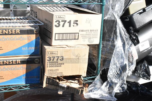 Green finish 4-tier wire shelving with Libbey 3715 and 3773 glass boxes and EZ Fit cup dispensers. Buyer must dismantle.