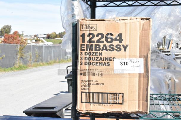 Green 4-tier wire shelving with EZ Fit cup dispensers and Libbey glasses. Box labeled "Libbey 12264 EMBASSY 3 dozen."