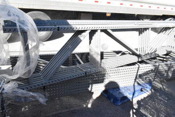 Lot of gray metal pallet racking pieces, 25x3x144.5, new condition. Ideal for warehouse storage solutions.