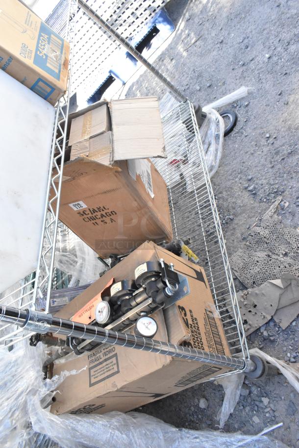 Chrome finish 3-tier wire shelving unit with contents, including a trash bin, Libbey beer glasses, and Dixie Ultra dispenser.