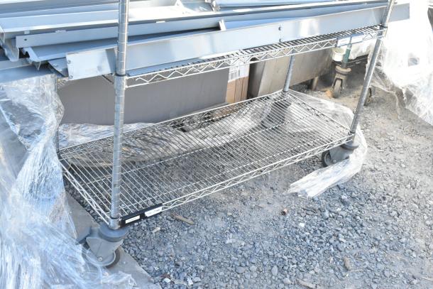 Chrome finish 4-tier wire shelving unit on commercial casters with metal pieces. Dismantling required for shipping.