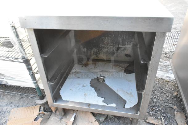 Stainless steel drain board with under shelf, exhibiting wear and rust. Ideal for kitchen use. Needs restoration.