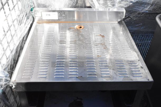 Stainless steel drain board with under shelf, perforated surface, visible wear, labeled 316. Ideal for commercial kitchen use.