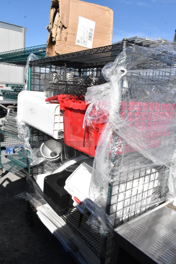 Black and green 4-tier wire shelving unit on commercial casters, contains various items, wrapped in protective plastic.