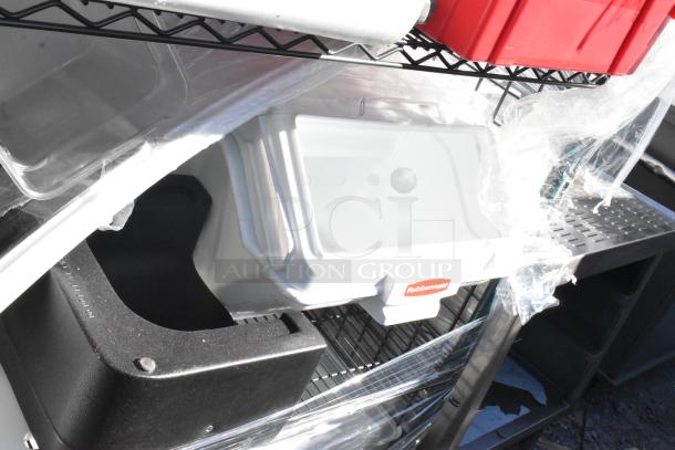 Black and green 4-tier wire shelving unit on commercial casters, includes contents. Buyer must dismantle. Rubbermaid bin visible.