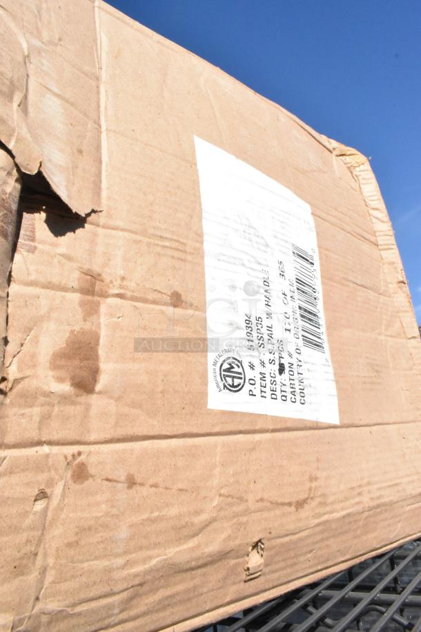 Cardboard box with a torn label showing item code and description. Box has visible water stains and wear.