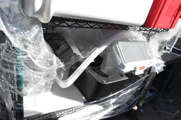 Black and green 4-tier wire shelving unit on commercial casters, wrapped, includes contents. Dismantling required.