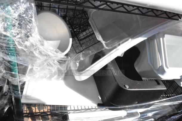 Black and green 4-tier wire shelving unit on commercial casters, holds bins and items. Buyer must dismantle. Freight charges apply.