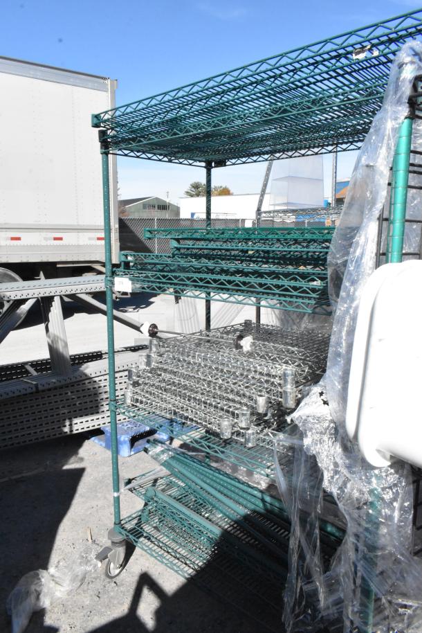 Green 4-tier wire shelving unit on commercial casters with contents. Includes assembly materials. Buyer dismantles. Consider freight.