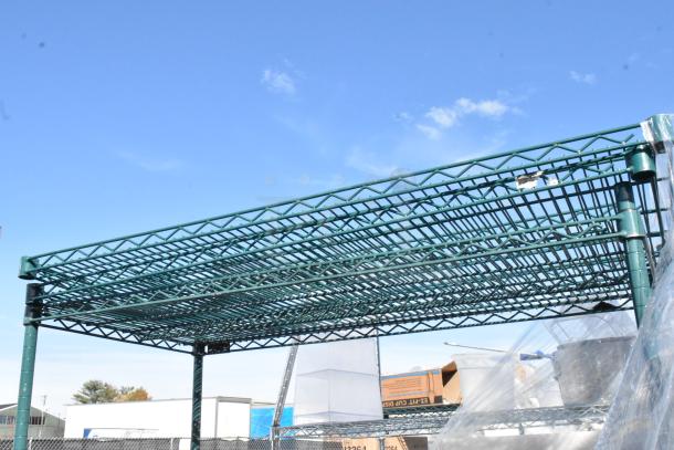 Green 4-tier wire shelving unit on commercial casters, with contents. Buyer must dismantle for shipping. Consider freight charges.