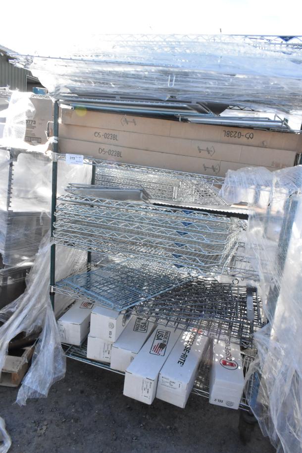 Chrome and green 5-tier wire shelving unit on commercial casters, includes contents. Buyer must dismantle; freight charges apply.