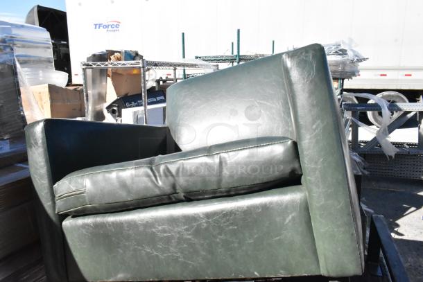 Five dark green leather chairs, lightly worn, stacked outdoors. Cushions appear intact. Auction includes all five chairs.