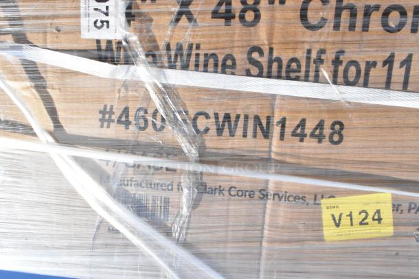 Pallet of new items including Regency wine shelf box, wrapped in clear plastic, marked #460ECWIN1448, tag V124 visible.