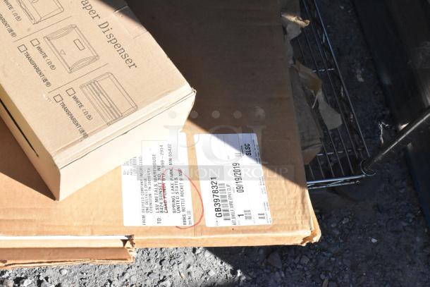 Chrome 4-tier wire shelving unit with cardboard boxes, including manufacturer's label. Buyer must dismantle.