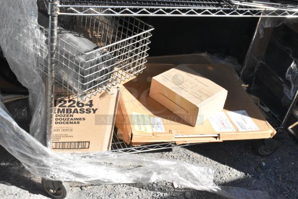 Chrome finish 4-tier wire shelving unit with boxes and a metal basket on wheels. Includes cardboard labeled "Libbey 12264 Embassy."