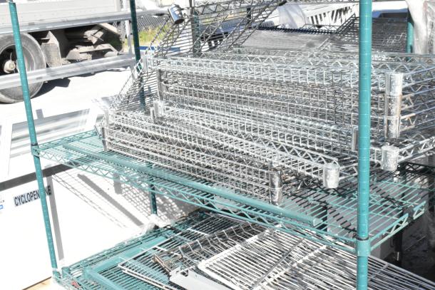 Green finish 4-tier wire shelving unit on commercial casters, includes wire shelves, requires dismantling, visible outdoors.