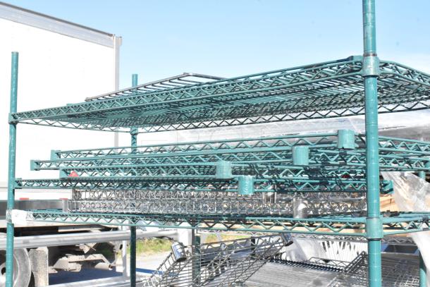 Green 4-tier wire shelving unit with commercial casters, includes wire shelves, requires buyer dismantling, suitable for freight.