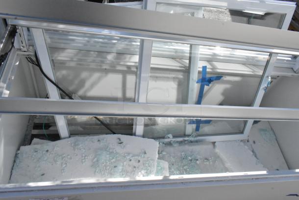 Avantco 193BCFD60W 59 1/8" white bakery display case with broken glass and interior shot; features LED lighting.