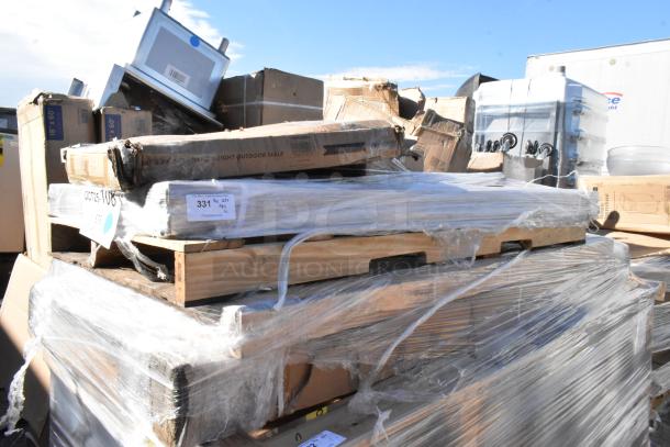 Pallet with new but scratch and dent furniture including tables and chairs, wrapped in clear film, marked for auction.