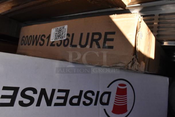 Stacked boxes showing labels: 600WS1236LURE and Dispense branding. Items include scratch and dent shelves, chairs, and dish table.